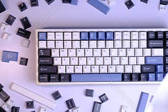 Close Up Modern 75% Layout Mechanical Keyboard with White, Blue, and Black Keycaps on a Clean White Desk