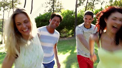 Four people holding hands as