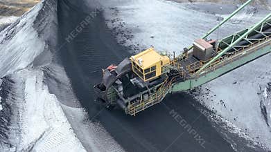 Flying over industrial port and warehouse for fossil fuels, coal and ore in the open air.