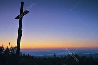 Cross silhouette with the sunset as background