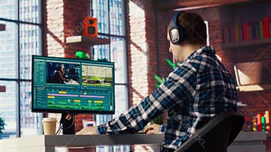 Videographer splicing film pieces on PC, editing them