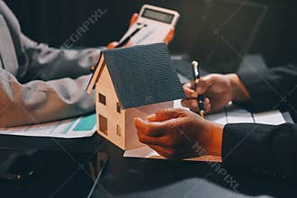 Close up Business people or Real Estate agent explain signing agreement for sale house to client. Property, Insurance, Broker
