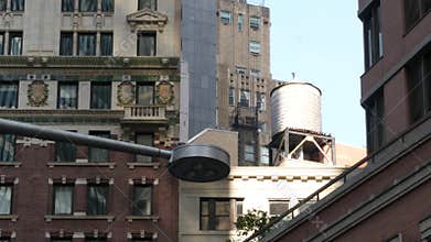 New York City building architecture. Residential house exterior. USA real estate. Rooftop water tower