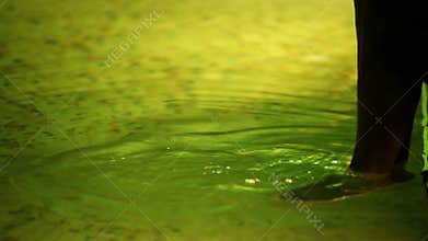 Young lady caresses legs in spa center pool