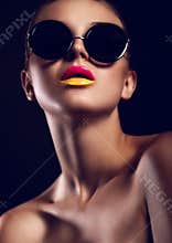 Glamor closeup portrait of beautiful stylish mode in sun glasses with bright colorful lips with perfect clean skin in studio