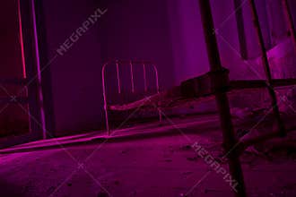 Light painted in pink abandoned bed in dark room. Halloween part