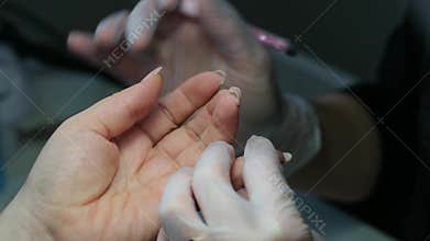 Transparent white latex gloves manicure nail technician performing gentle beautiful nail care professional salon close
