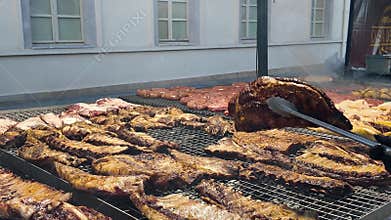 Juicy pork ribs grilling on a barbecue grate Cooking marinated bbq ribs close up Delicious roasted pork ribs on grill