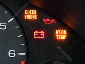 Check engine and other warning signage on car dashboard