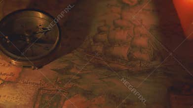 A compass near the two lit candles