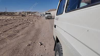 Off-road safari convoy driving through egyptian desert