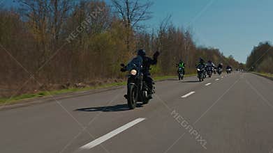Steadicam tracking shot of a large motorcycle convoy on a highway