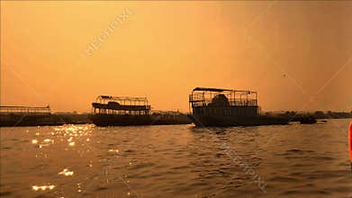 Golden sunset over river from moving boat scenic India water travel view