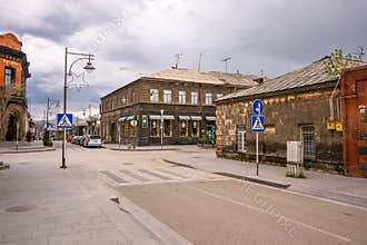 Quiet town street with historic architecture and cloudy sky