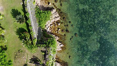 Cinematic bird-eye drone flyover of Fort Santa Isabel in Taytay, Palawan. The coral-stone