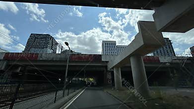 Low-angle view of modern office towers and tram lines above city