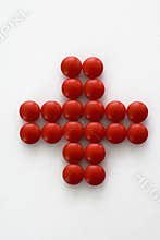 Pills in form of red cross