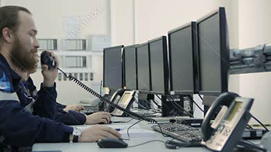 Side View Serious Men in Uniform Sit and Look at Monitors