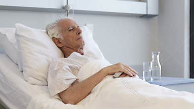 Old happy patient lying on bed