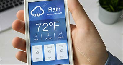 Checking wather using smartphone app. Rainy and cloudy weather