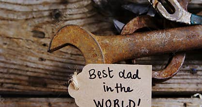 Happy fathers day card with old work tools on wooden plank