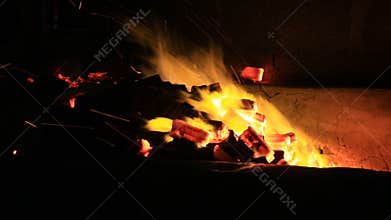 Worker working on fire burning on coal