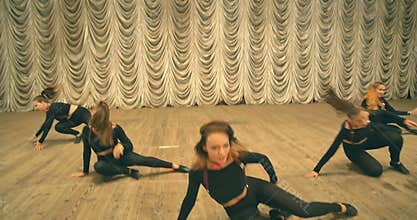 Contemporary dance performance of dancers on the stage. Front view.