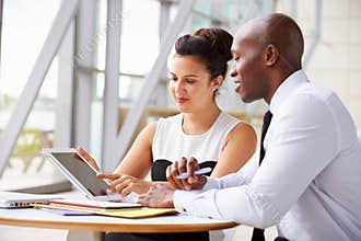 Two corporate business colleagues working together in office