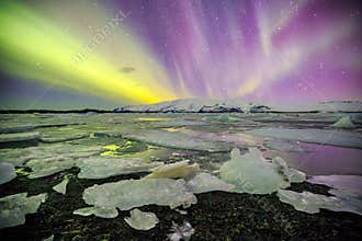 Auroral over the glacier lagoon Jokulsarlon in Iceland.