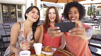 Three Female Friends Taking Selfie In Cafï¿½