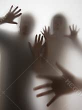 Shadows of people behind transparent paper