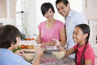 Family In Kitchen Eating Breakfast