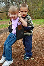 Brother and sister swinging