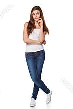 Young beautiful woman thinking looking to the side at blank copy space, full length, isolated over white background
