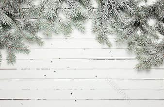 Christmas and New Year decoration composition. Top view of fur-tree branches on wooden background with place for your