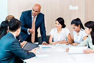 Diversity team in business development meeting with charts