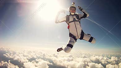 Professional skydivers jump from airplane, freestyle in cloudy sky. Adrenaline.