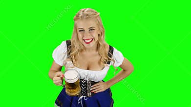 Bavarian girl with a glass of beer in his hand flirts. Green screen