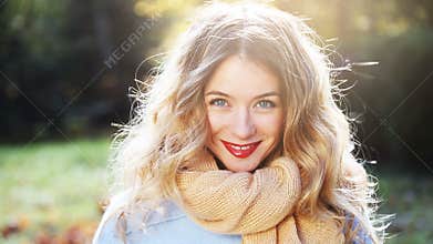 Smiling Fashion Woman in Sunny Autumn Day