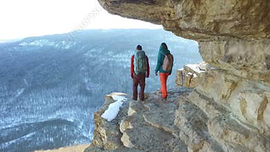 Travelers walking on edge of cliff