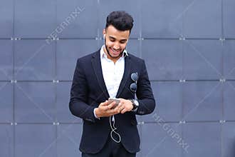 Handsome arabic man takes selfie smart phone in business center