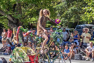 Man rides a decorated bike in parade