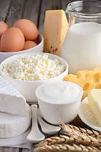 Fresh dairy products. Milk, cheese, brie, Camembert, butter, yogurt, cottage cheese and eggs on wooden table.