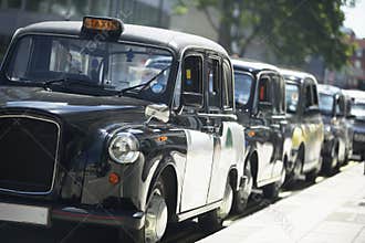 London Taxis Lined Up On Sidewalk
