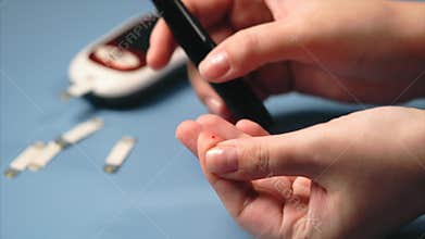 Woman making blood sugar test. Self-testing for diabetes.
