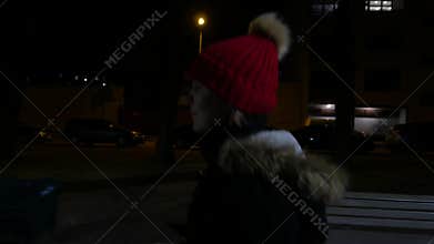 Lonely girl walking at night. Night city, 4K UHD