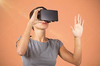 Composite image of young woman wearing virtual video glasses