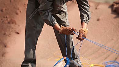 Preparation of an explosion in the quarry, workers are preparing charges, iron mine, blasting in iron ore quarry