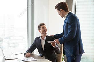 Boss giving money premium to happy employee