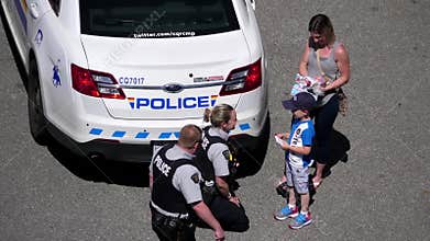 Top shot of police officer hugging with children